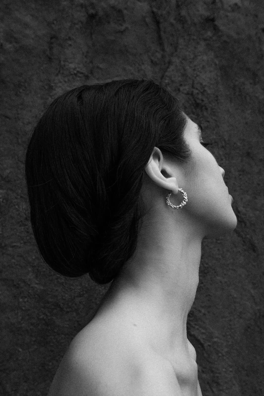 Black and white profile with hair pulled back and a hoop earring — LES SOLIDES, by Kenneth Kemp