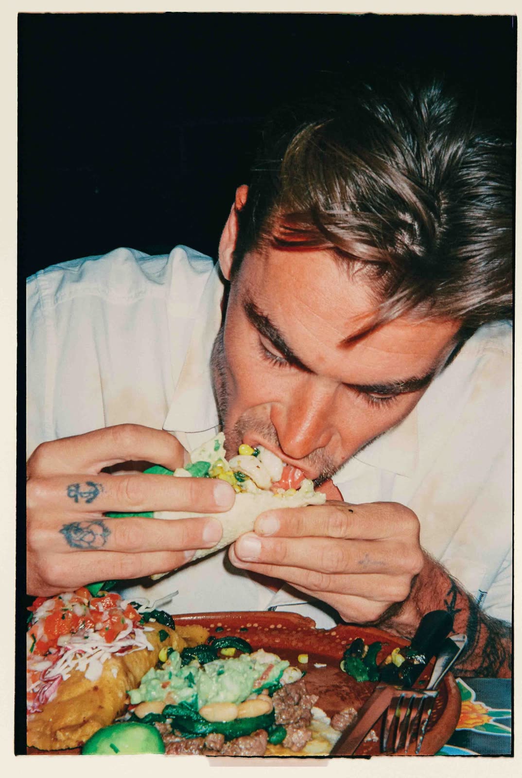 Flash frame of a man eating at a table, film border — HURLEY, by Kenneth Kemp