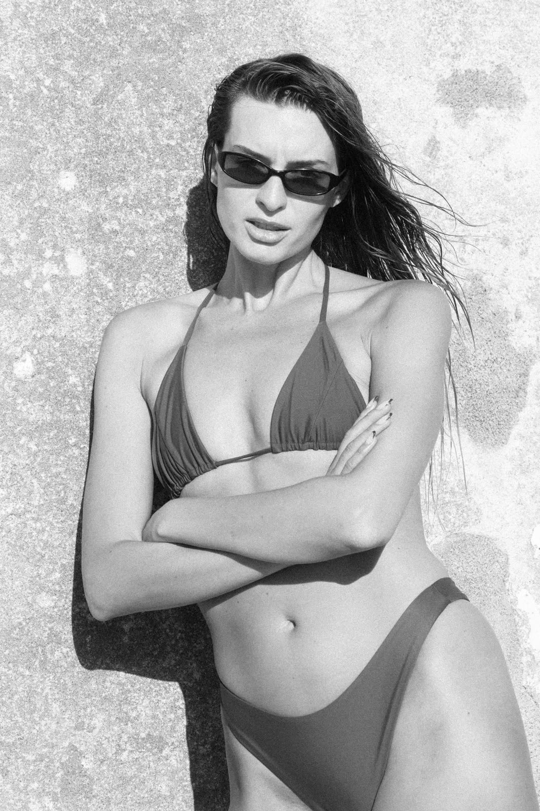 Black and white frame in a bikini and sunglasses against a textured wall — CRISTINA, by Kenneth Kemp