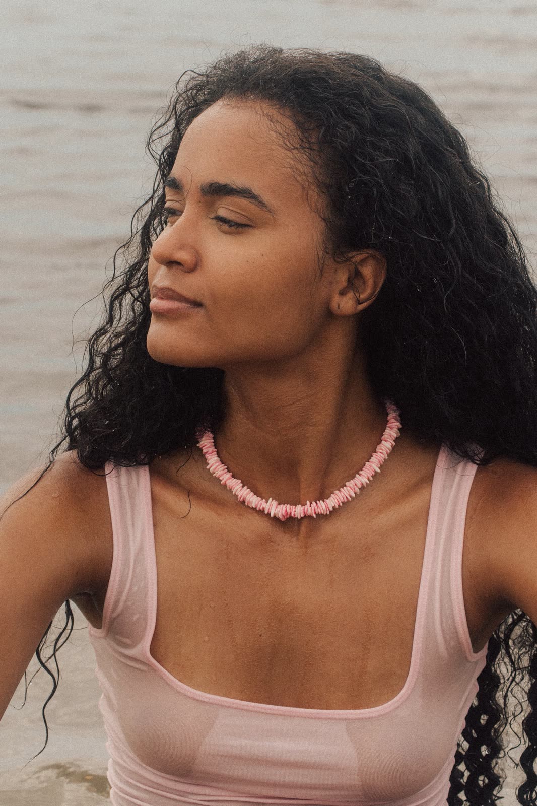 Portrait of a model in a pink tank and beaded necklace in soft beach light — LAILA, by Kenneth Kemp